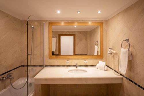 a bathroom with a sink and a mirror at Mitsis Norida in Kardamaina