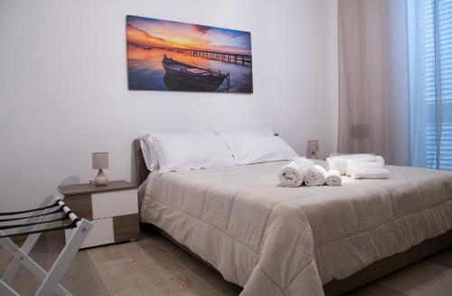 a bedroom with a bed with towels on it at Borgo Dei Cedri in Bari