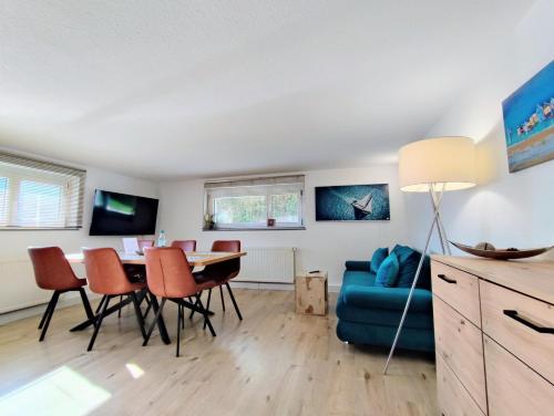 a living room with a blue couch and a table at FeWo Heimathafen in Bodman-Ludwigshafen