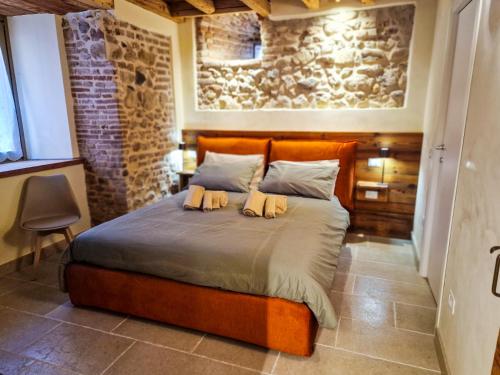 a bedroom with a bed with two pillows on it at Sotto la Torre in Marostica