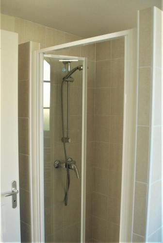 a shower with a shower head in a bathroom at COQUETTE MAISON in Tocane-Saint-Apre