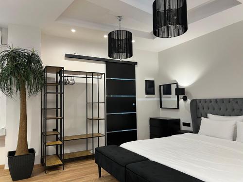 a bedroom with a bed and a plant and lights at Apollonio Suites in Korinthos