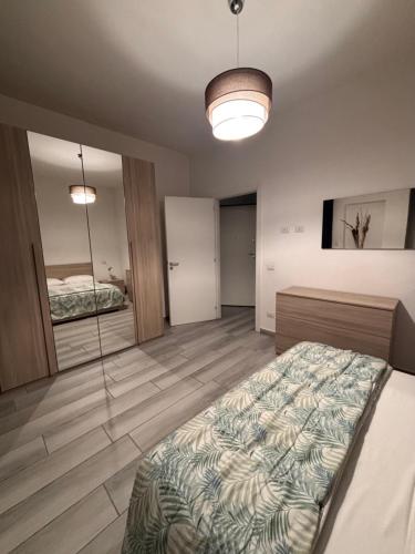 a bedroom with a bed and a mirror at Carlotta 5 in Biella
