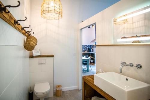 a bathroom with a sink and a toilet at Welcôm Apparts-chic et intimiste-100m du Port in La Teste-de-Buch