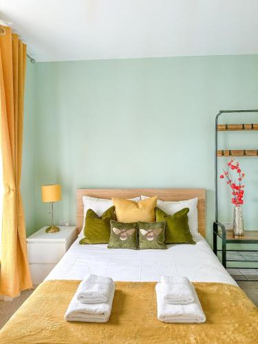 a bedroom with a large bed with two towels on it at Camden Rooms in London