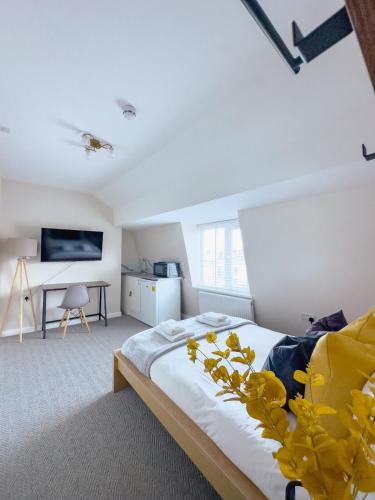 a bedroom with a bed with yellow flowers on it at Camden Rooms in London