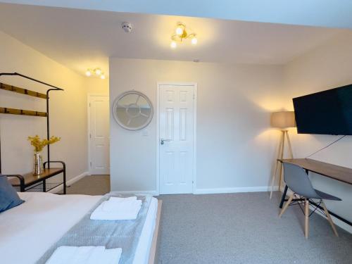 a bedroom with a bed and a desk and a computer at Camden Rooms in London