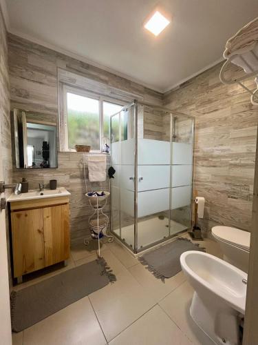a bathroom with a shower and a toilet and a sink at Green Sunrise House in Nordeste