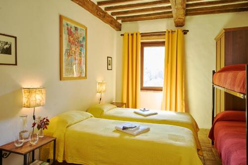 a hotel room with two beds and a window at Agri Ostello Valle Libera in Chianaiola