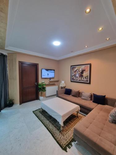 a large living room with a couch and a tv at Perle studio lac 2 tunisia mall in Tunis