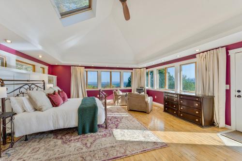 a bedroom with a large bed and a living room at Heritage Hollow in Cambridge