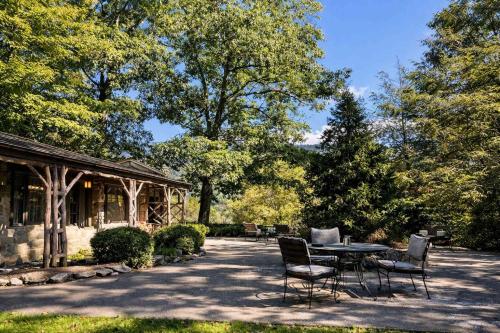 a patio with a table and chairs and a gazebo at Storybook Three Cottage Mountain Compound in Banner Elk