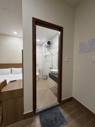 a bathroom with a shower and a sink and a mirror at Rosie Hotel in Da Thien