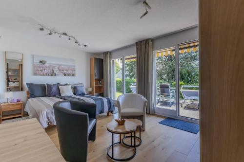 a bedroom with a bed and a table and chairs at Ferienwohnung Schwyz in Schwyz