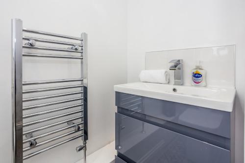 a bathroom with a sink and a mirror at 61 Deneside in Lanchester