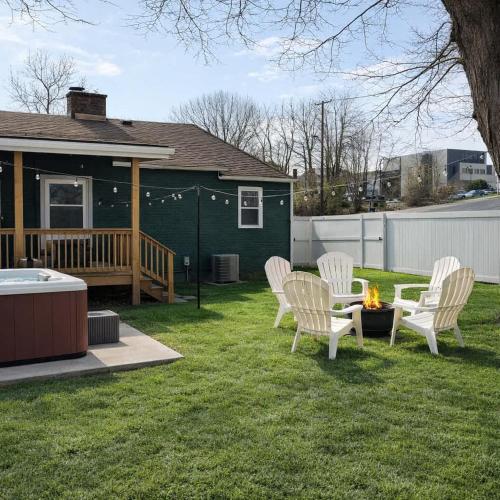 a group of chairs and a fire pit in a yard at Honeybee Bungalow with Hot Tub in Bristol
