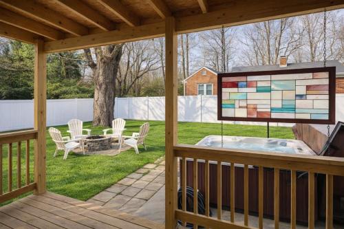 a screened porch with a jacuzzi in a backyard at Honeybee Bungalow with Hot Tub in Bristol