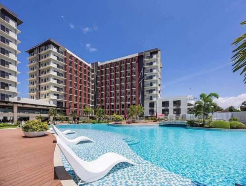 a large swimming pool in front of a building at KEY REALTY SERVICES Ph in Pajak