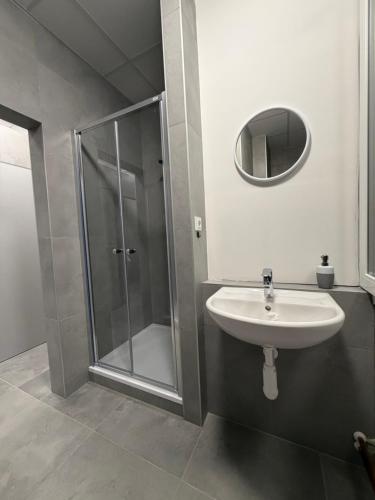 a bathroom with a sink and a shower at Penzion BETA in Třebíč