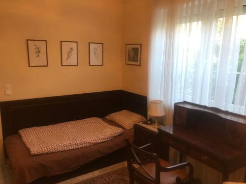 a bedroom with a bed and a desk and a television at Ferienhaus Marhardt in Oslip