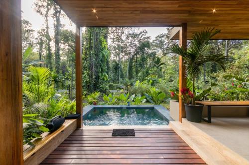 an indoor pool in a house with a garden at Con Amor Caribe - New 240 sqm Villa & Private Pool in Puerto Viejo