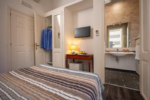 a small bedroom with a bed and a sink at Al Bastione di Cagliari in Cagliari