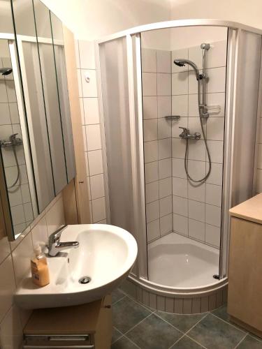 a white bathroom with a shower and a sink at Sonnenalpe ckpk in Hermagor