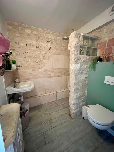a bathroom with a toilet and a sink at La mésAnges in Giverny