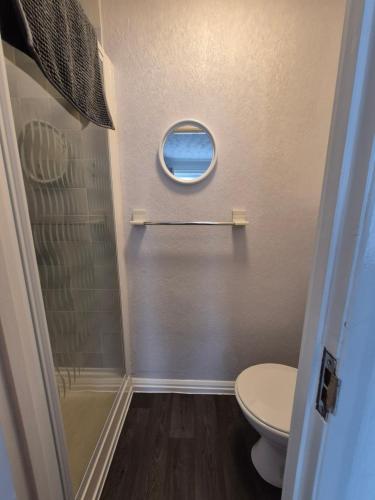 a small bathroom with a toilet and a window at The Clifton at Paignton in Paignton