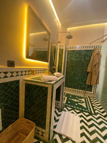 a bathroom with a sink and a mirror at RIAD KS & SPA in Marrakesh