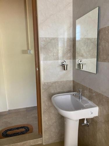 a bathroom with a sink and a shower with a mirror at Road Trip Retreat in Belagula