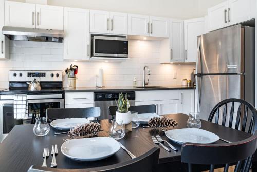 a kitchen with a table with chairs and a dining room at The First Tracks Flat in Revelstoke