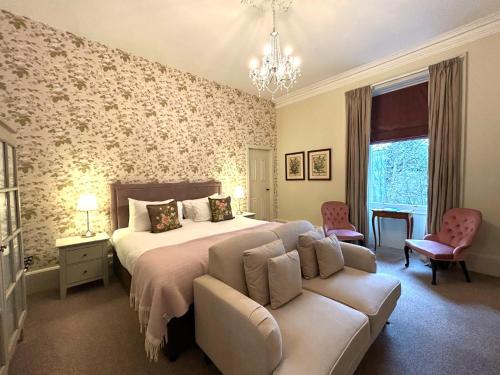 a bedroom with a bed and a couch at Birchwood Pitlochry in Pitlochry