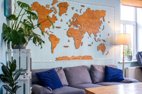 a living room with a map of the world on the wall at Central Hostel in Riga