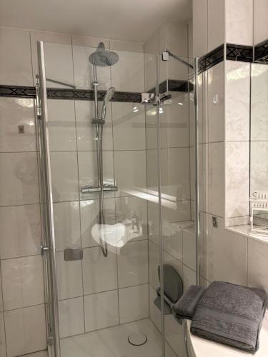 a shower with a glass door in a bathroom at MeerZeit in Bad Zwischenahn