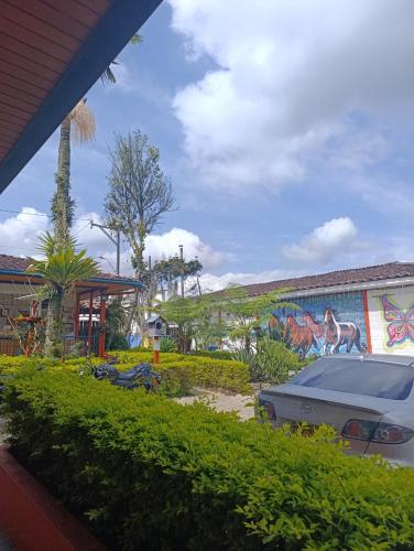 a mural of a car parked in front of a building at Hotel Dulce Campestre in Jardin
