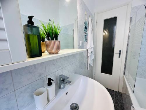 a white bathroom with a tub and a sink at Piccolo Rifugio by anbra Properties --- WITH PARKING AND FREE WIFI in Rapallo