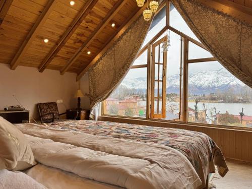 a large bed in a room with a large window at Weather cottage in Srinagar