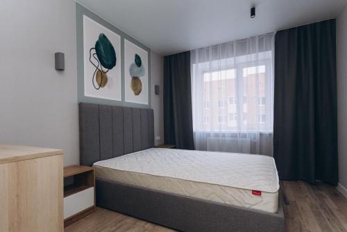 a bedroom with a bed and a window at 2 кім кв BIG APARTMENT TOP Center in Sumy
