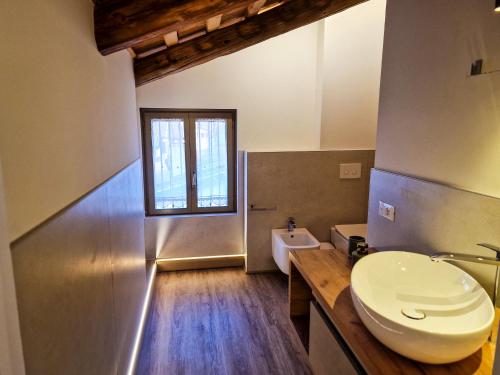 a bathroom with a white toilet and a sink at Il Rivellino in Marostica