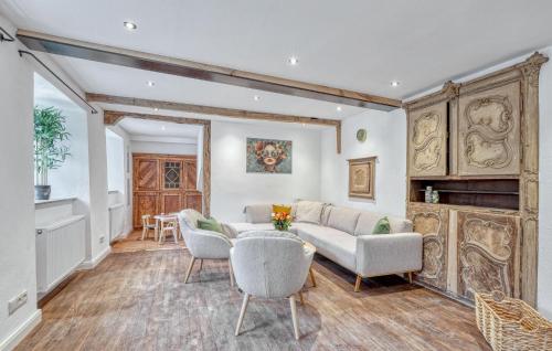 a living room with a couch and chairs and a fireplace at Munkler Mühle Whg 1 in Irrhausen