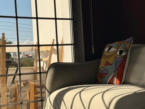 a bedroom with a couch and a window with a view at The Family House in Larnaca