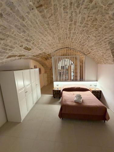 a bedroom with a bed and a stone ceiling at Virgin Mare in Giovinazzo