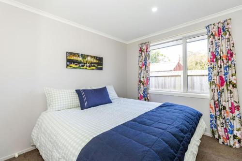 a bedroom with a bed and a window at Contemporary Methven Abode in Methven
