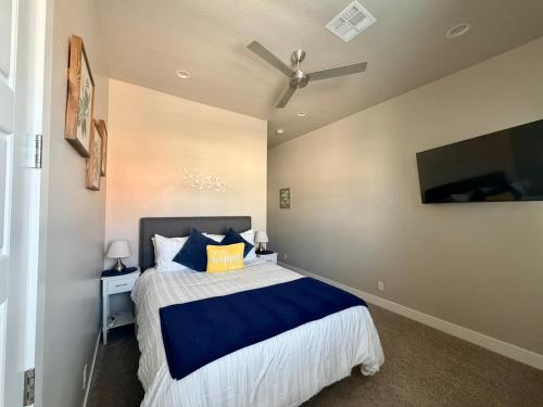 a bedroom with a large bed and a flat screen tv at Kantada in the Sun - Poolside Retreat in Santa Clara