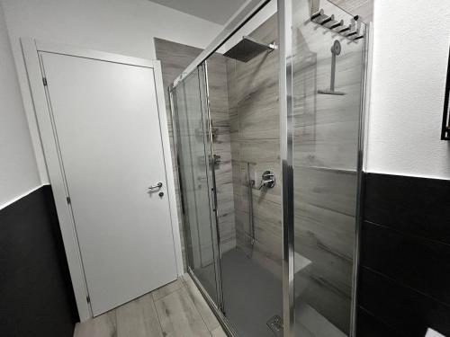 a shower with a glass door in a bathroom at My Home Lainate Historic Center in Lainate