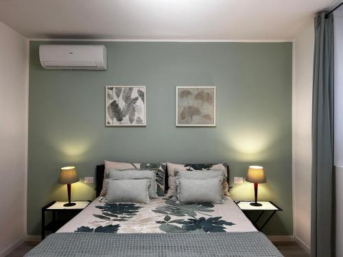 a bedroom with a large bed with two lamps at My Home Lainate Historic Center in Lainate