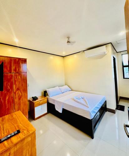 a bedroom with a large bed in a room at Arron Grand Inn in Zamboanga