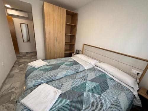 a bedroom with a bed with two towels on it at Alojamientos CASTILLA-AGAVE in Tabernas