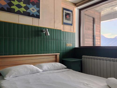 a bedroom with a bed and a window at Tsar Bani Spa Resort in Gudauri